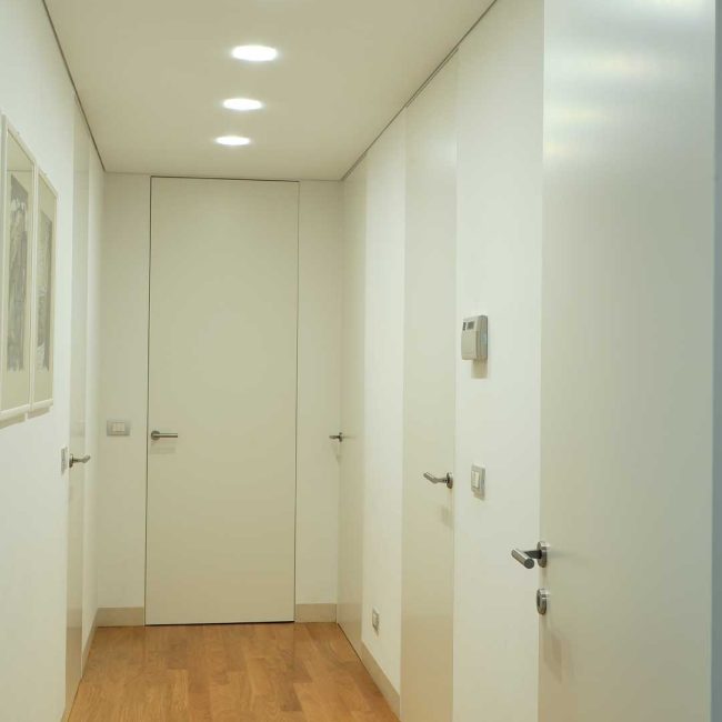 Corridoio di porte e battiscopa filo muro